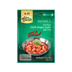 Green color sachet of Asian Home Gourmet Spice Paste for Szechuan Chili Ginger Garlic Stir Fry. Hot level. A picture of shrimp with sauce in a traditional wok and green onion garnish is shown in the front image of the package. Net weight 1.75 oz or 50 gr